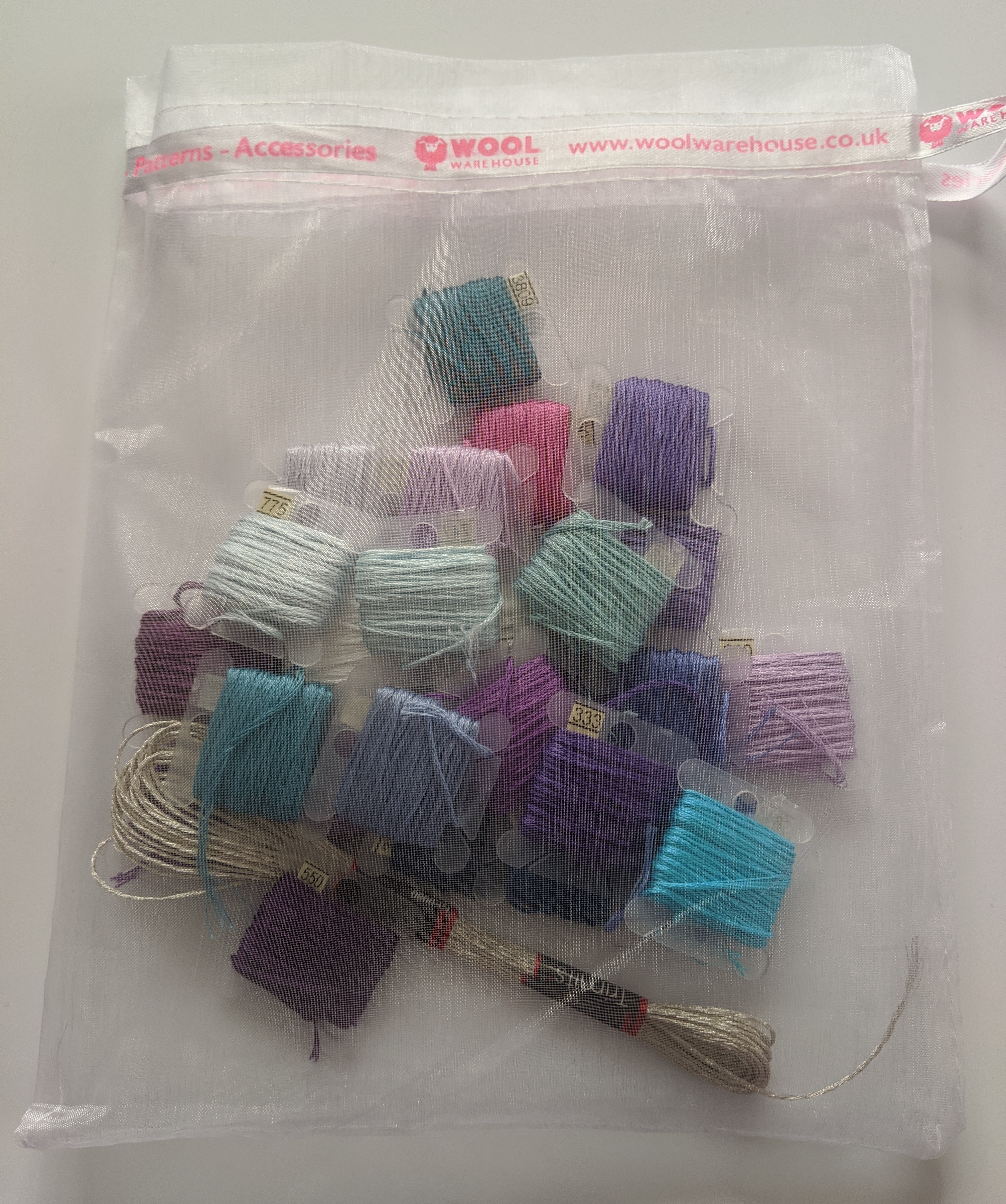 A bag of coloured thread on bobbins